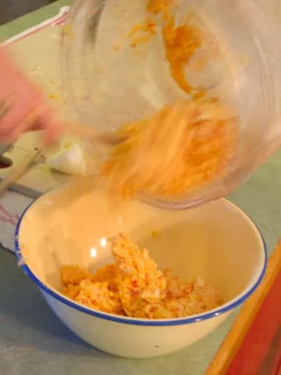 Putting the pimento cheese balls mixture into a bowl