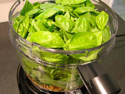 Pesto ingredients in a food processor