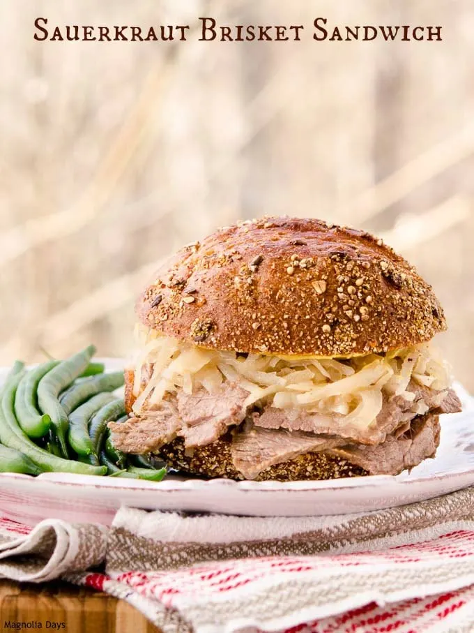 Sauerkraut Brisket Sandwich is made with slow-simmered beef brisket topped with sauerkraut in a wheat roll.