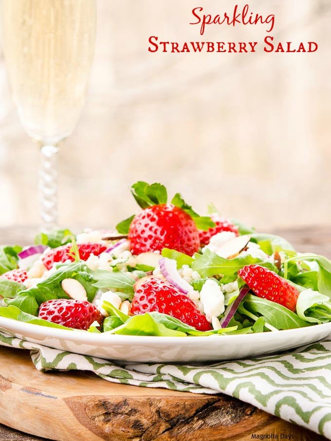 Sparkling Strawberry Salad is a delightful mix of greens, couscous, fresh strawberries, almonds, feta cheese with sparkling almond dressing.