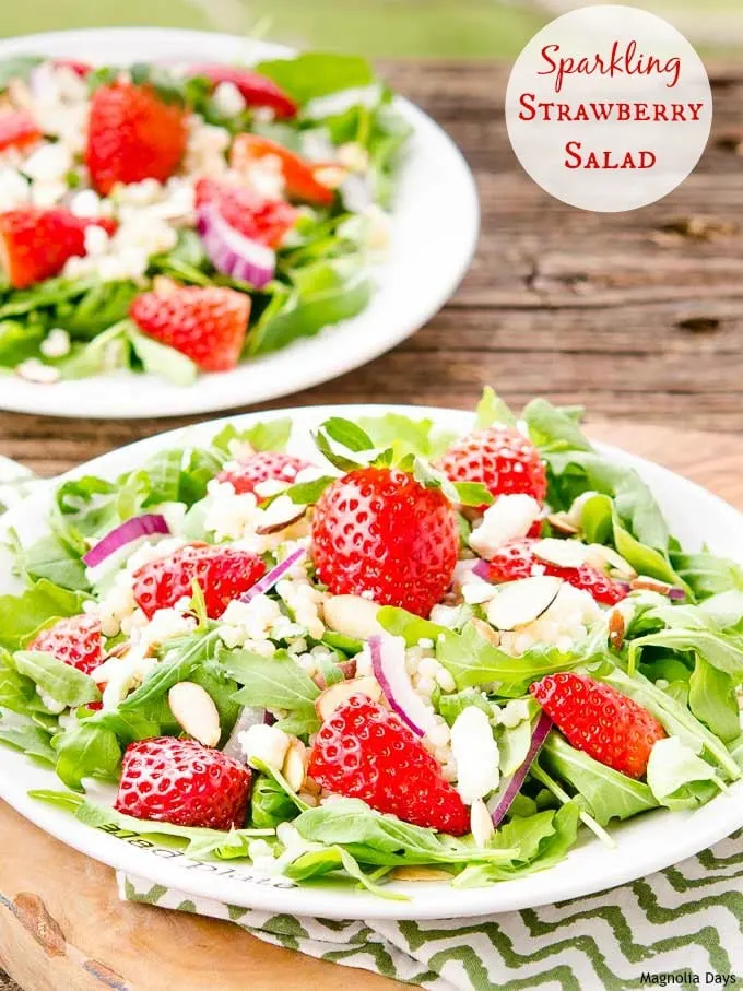 Sparkling Strawberry Salad is a delightful mix of greens, couscous, fresh strawberries, almonds, feta cheese with sparkling almond dressing.