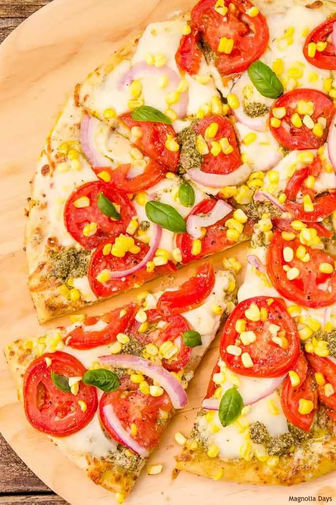 Corn and Tomato Pizza is a tasty meal that's easy to make with pre-made crust and pesto. Use fresh-picked corn and tomatoes to make it spectacular.