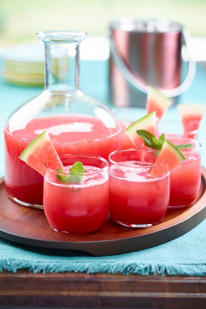 Watermelon mint agua fresca in a glass pitcher and cups