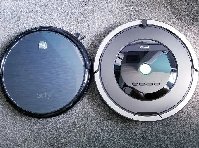 Eufy Robovac 11 and iRobot Roomba 801 on grey carpet