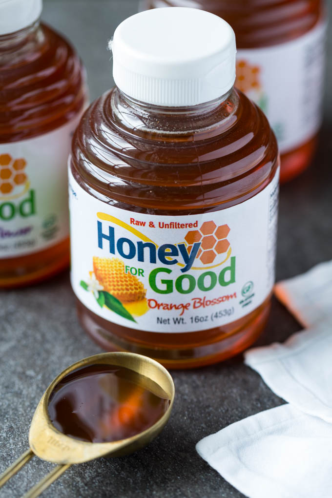 Honey in a clear bottle labeled Honey for Good Orange Blossom