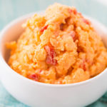 Bowl of easy pimento cheese recipe made with cheddar cheese, pimento peppers, mayonnaise, and sugar