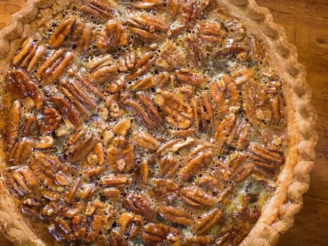 Whole Karo syrup pecan pie on a wood table