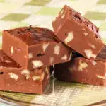 Old fashioned fudge with walnuts on a glass plate