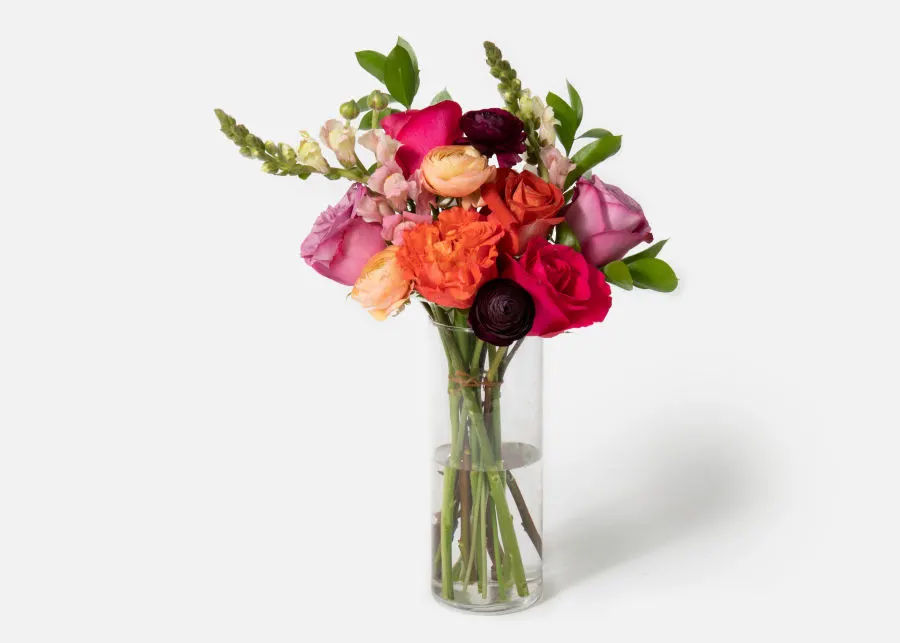 Carnival UrbanStems bouquet in a clear glass vase as pictured on UrbanStems website